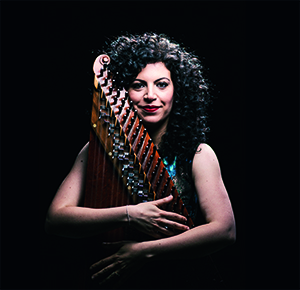 A musician with her instrument, a zither